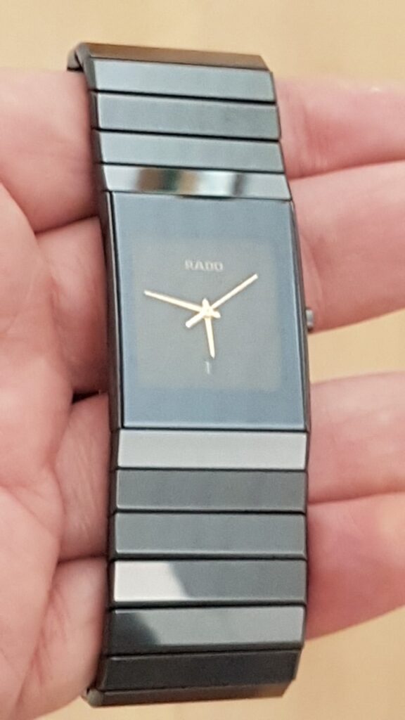 Rado watch, simple modern styling, shown on a hand.