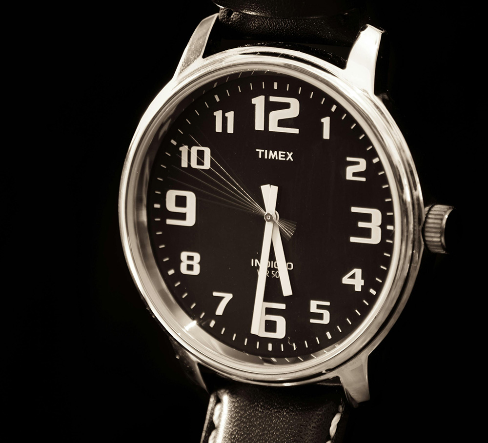 Timex watch, brown, on black background