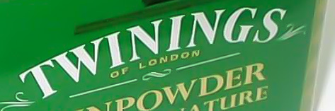 Twinings logo, white on green tea tin, photo.