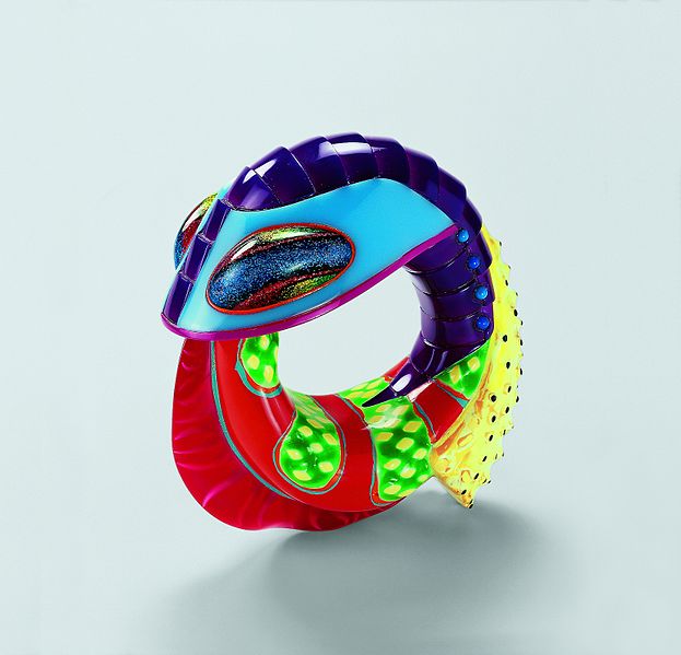 PeterChang art jewellery in bright colours resting on a white surface