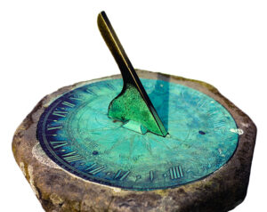 Sundial with green patina, isolated on white background