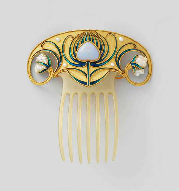 art nouveau jewellery gold and blue, on a white surface