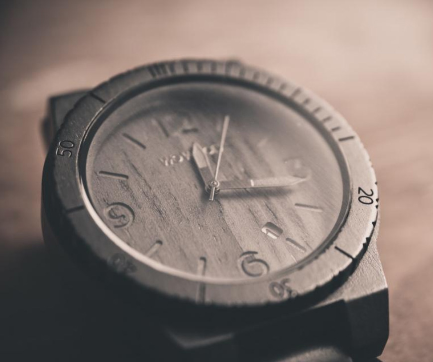 WeWood wooden watch, 3/4 view with shallow depth of field, on brown background