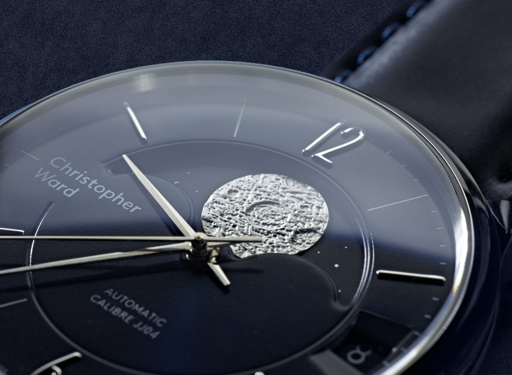 Christopher Ward C9 Moonphase - an unusual watch, closeup/detail on black background.