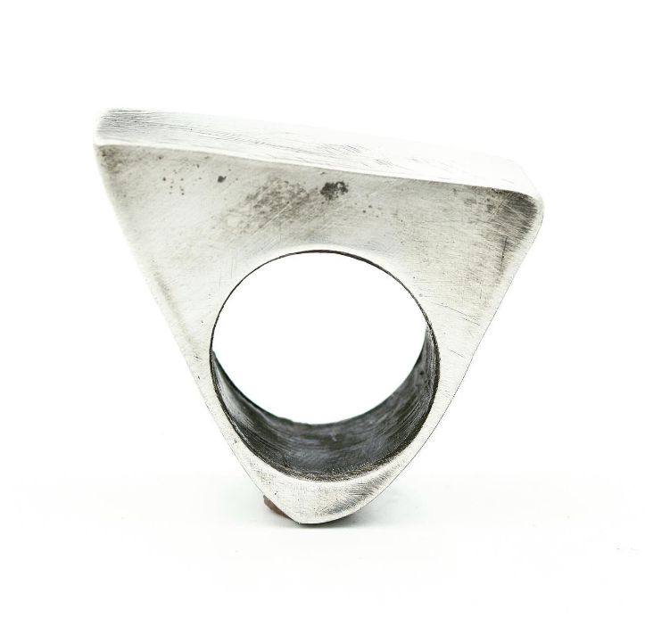 Art jewelry by Jill Herlands, unpolished silver on white background.