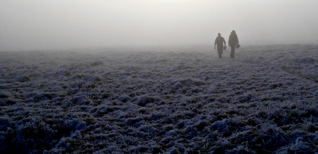An example of the rule of thirds in photography aesthetics, showing 2 people walking in winter landscape with mist