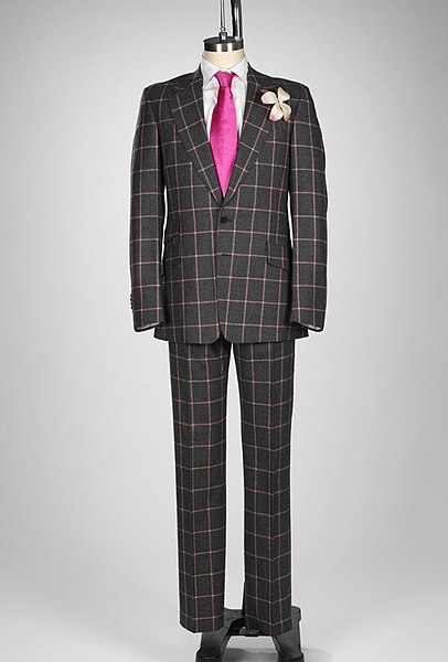 Paul Smith suit, dark, with bright pink tie, on mannequin - a British luxury brand.