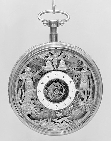Decorated watch, with metal illustrations - showing decoration as part of watch aesthetics.