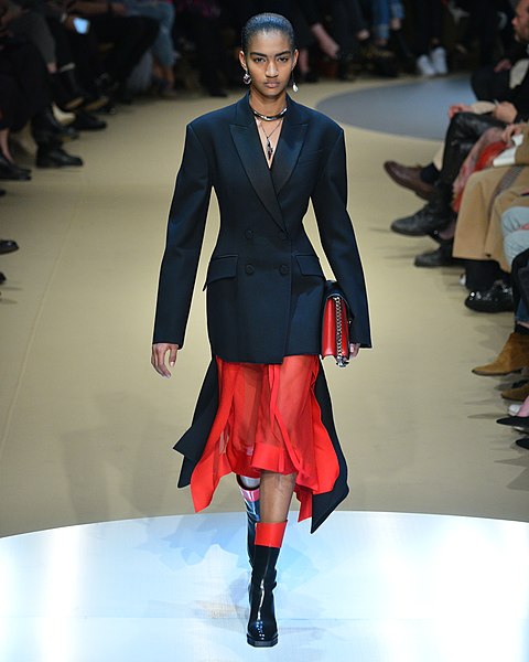 Alexander McQueen, red skirt, black jacket, catwalk model - A British luxury brand