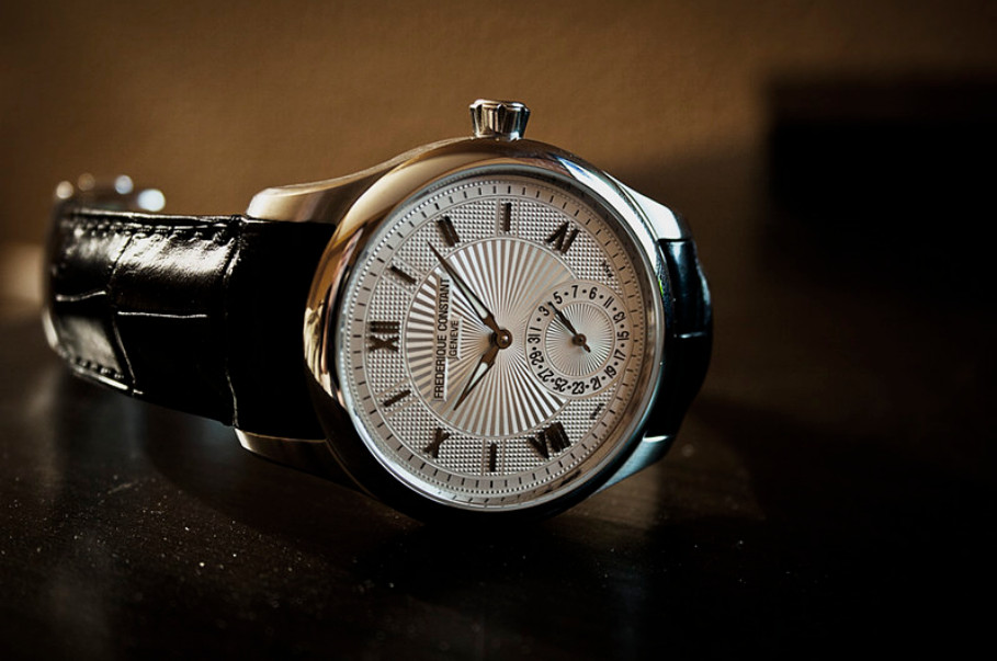 Frederique Constant Maxi Manufacture Silver Guilloche watch, shown on dark wood surface