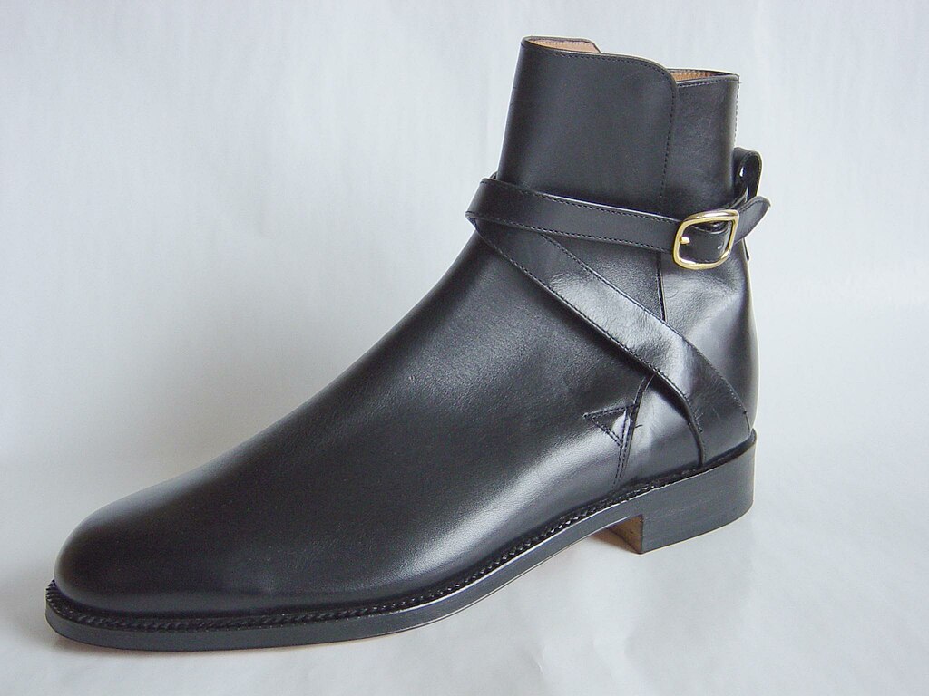 Grenson footwear, black high-ankle shoe, on white surface.