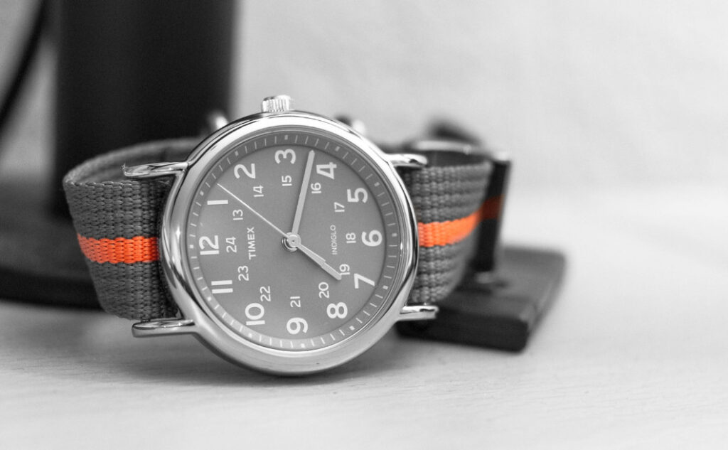 Timex Weekender - grey watch aesthetic with grey fabric strap with an orange stripe.