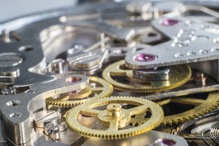 Watch manufacture, closeup/detail of watch mechanism with jewels.