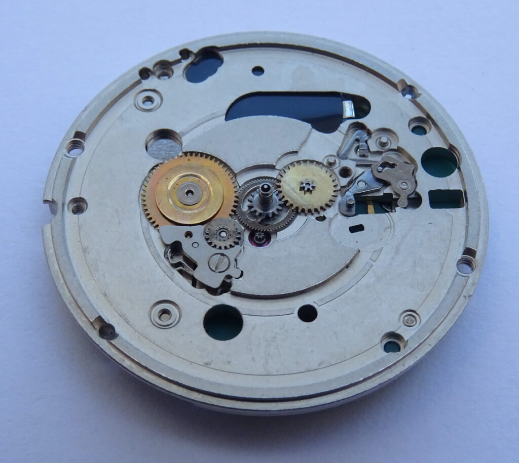 ETA watch movement on a white surface.