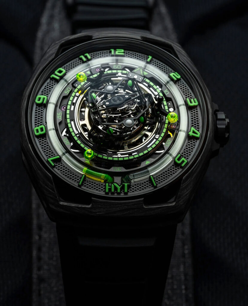 HYT ConicalTourbillon watch with fluidic time-display, green and black, on a black background.