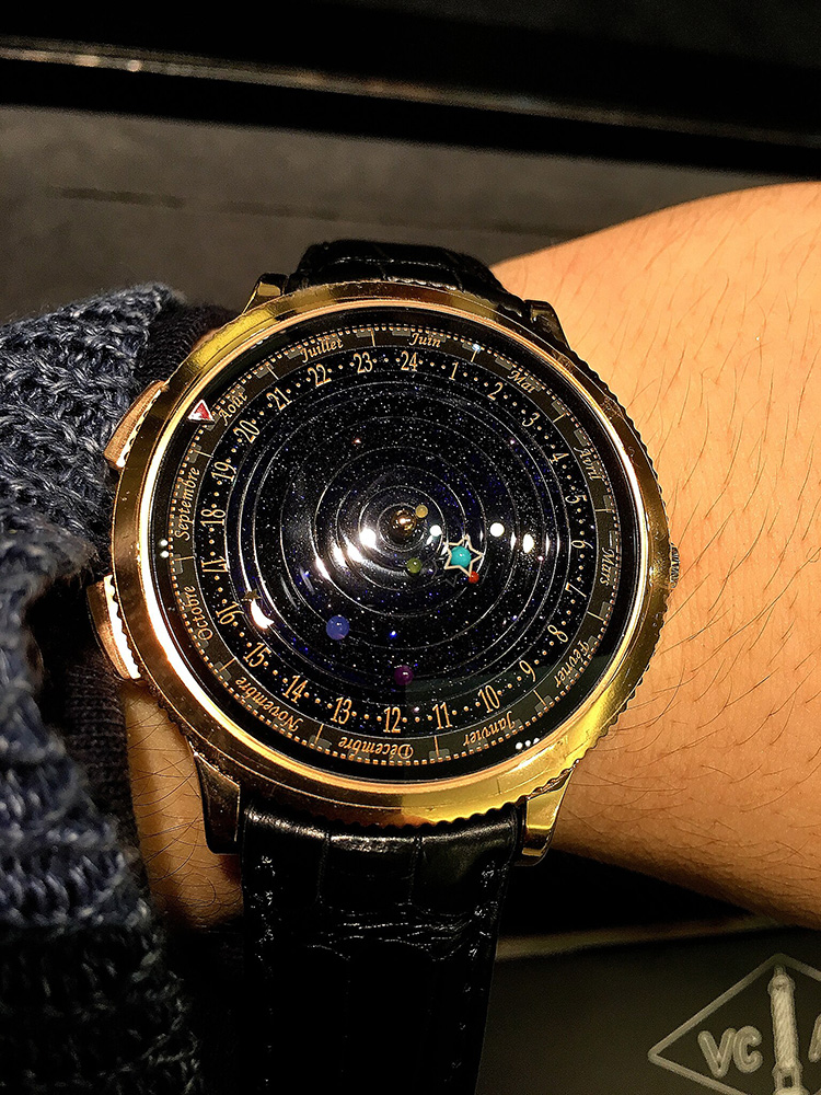 Van Cleef & Arpels midnight planetarium watch, shown on a wrist.