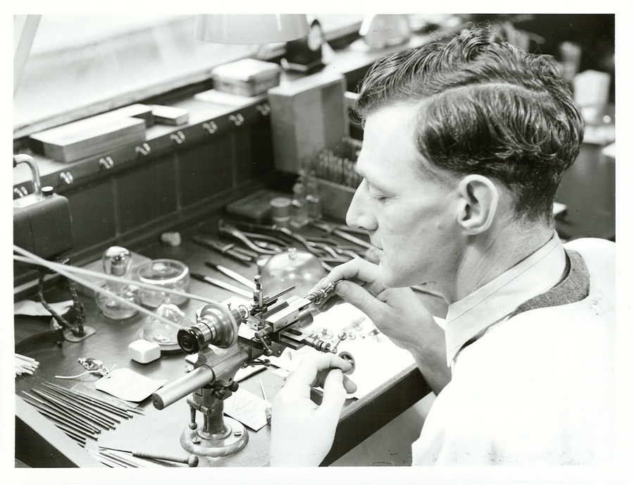 A watchmaker shown using traditional tools. Black and white photograph.