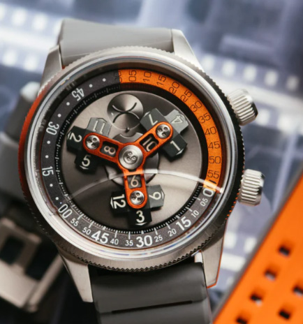 Xeric watch, with orange accents, on a complex background.
