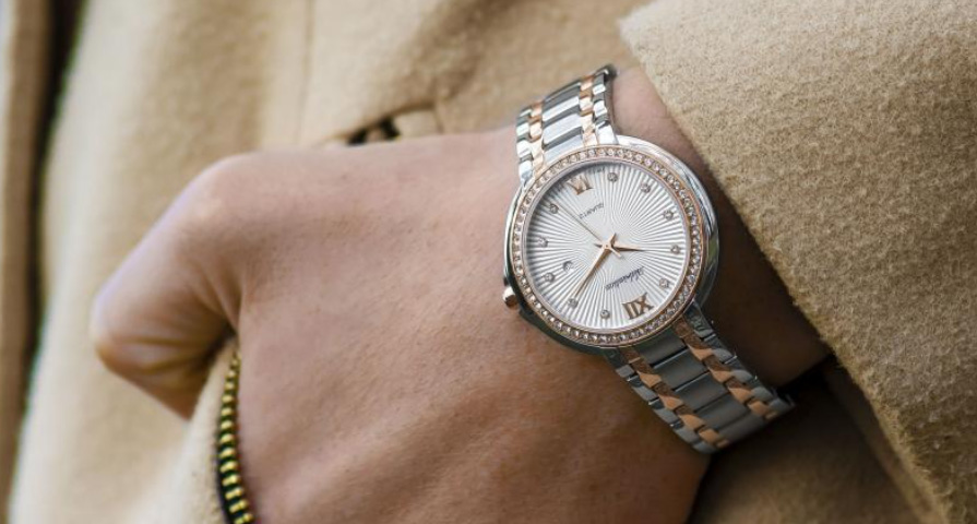 A woman wearing a watch on her wrist, with her hand in her pocket, luxury style.