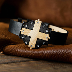Cross #1 watch, in blackened silver with aspen wood, resting on leather and wood table - thumbnail