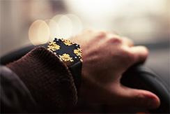 Cross #1 watch gold and ebony, worn by man driving car, Thumbnail