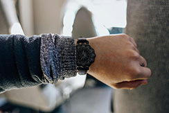 Poppy Seed-pod watch, blackened silver, worn on the wrist, room background. Thumbnail