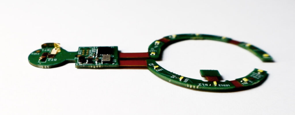 UnconstrainedTime printed-circuit-board, on white paper surface.