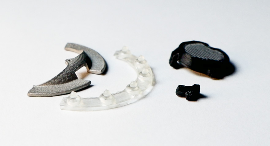 UnconstrainedTime watch internal parts, on a white surface.