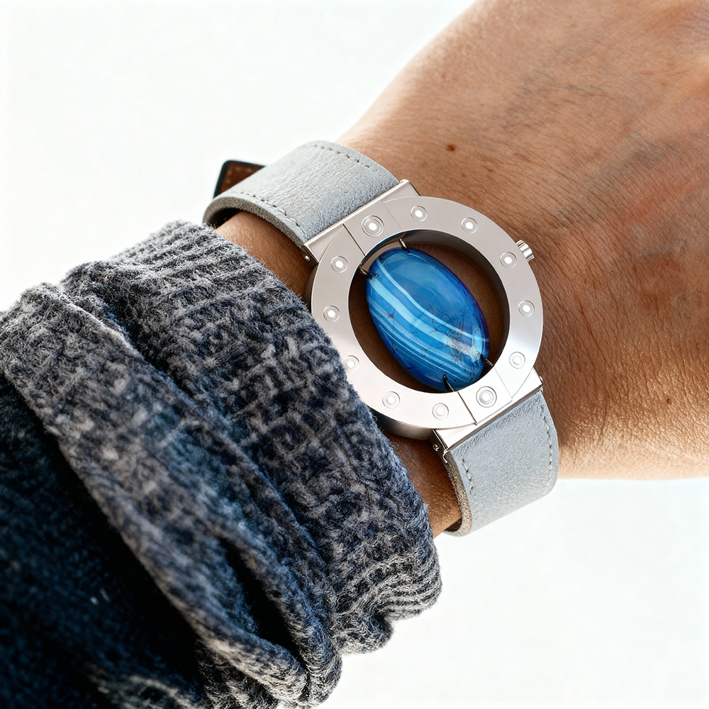Stone-hold wristwatch in silver with blue agate worn on a wrist.