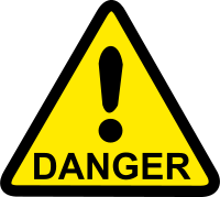 Danger sign with exclamation mark in triangle, with a yellow background.