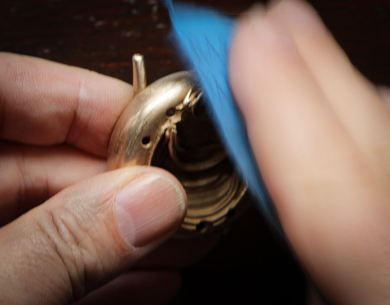 Polishing a Fractal Emergence watch body/case with sandpaper.