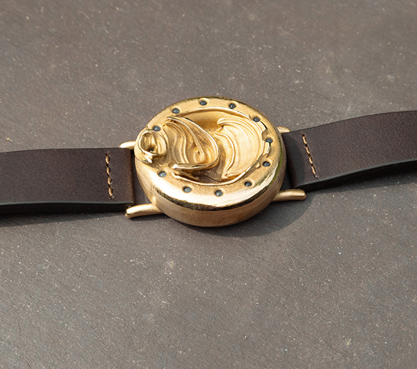UnconstrainedTime Fractal Emergence wristwatch, view from above, on a slate surface.