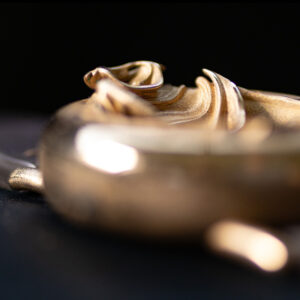 UnconstrainedTime Fractal Emergence 41mm wristwatch in bronze, closeup, shallow depth of field, dark background.
