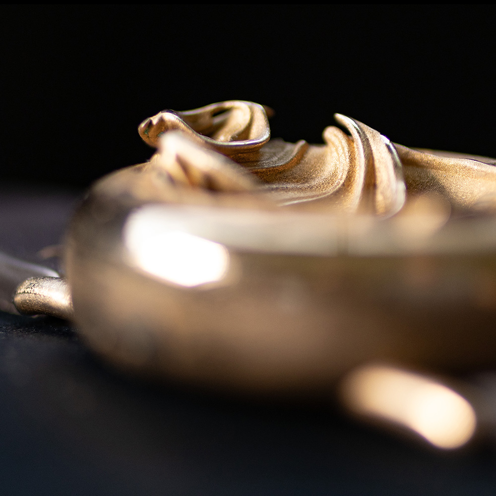 UnconstrainedTime Fractal Emergence 41mm wristwatch in bronze, closeup, shallow depth of field, dark background.