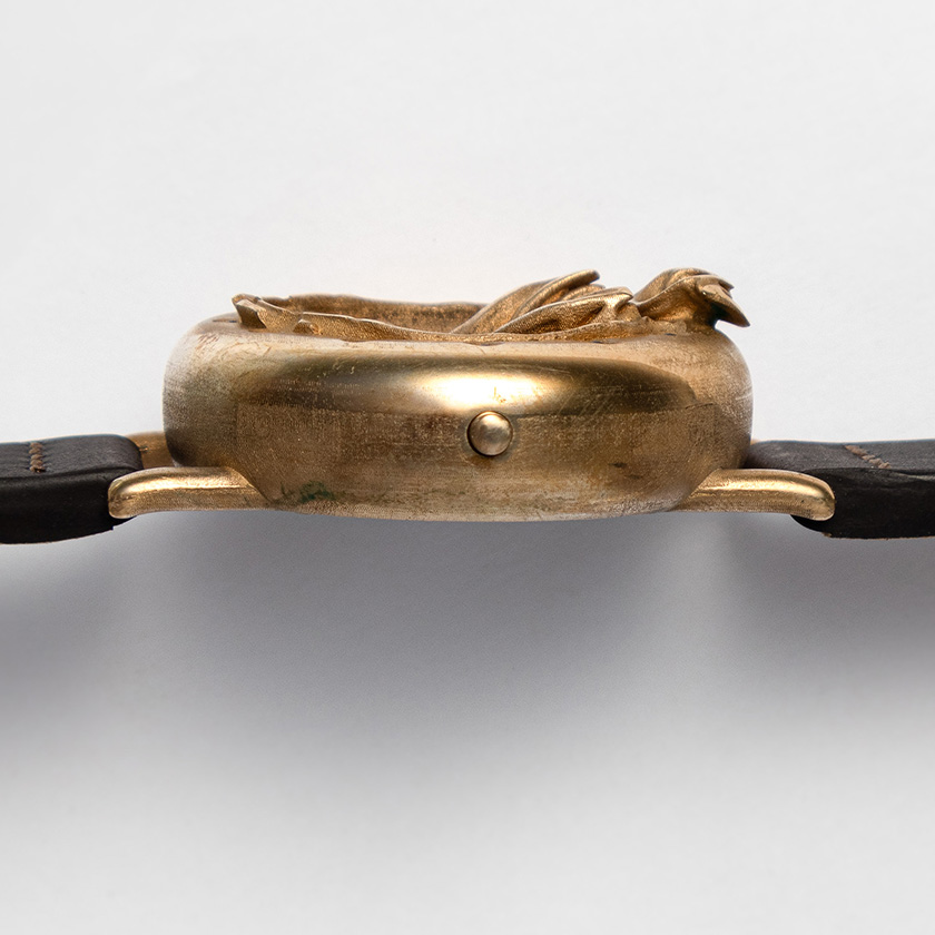 UnconstrainedTime Fractal Emergence wristwatch in bronze, side view on white paper, with brown leather strap.