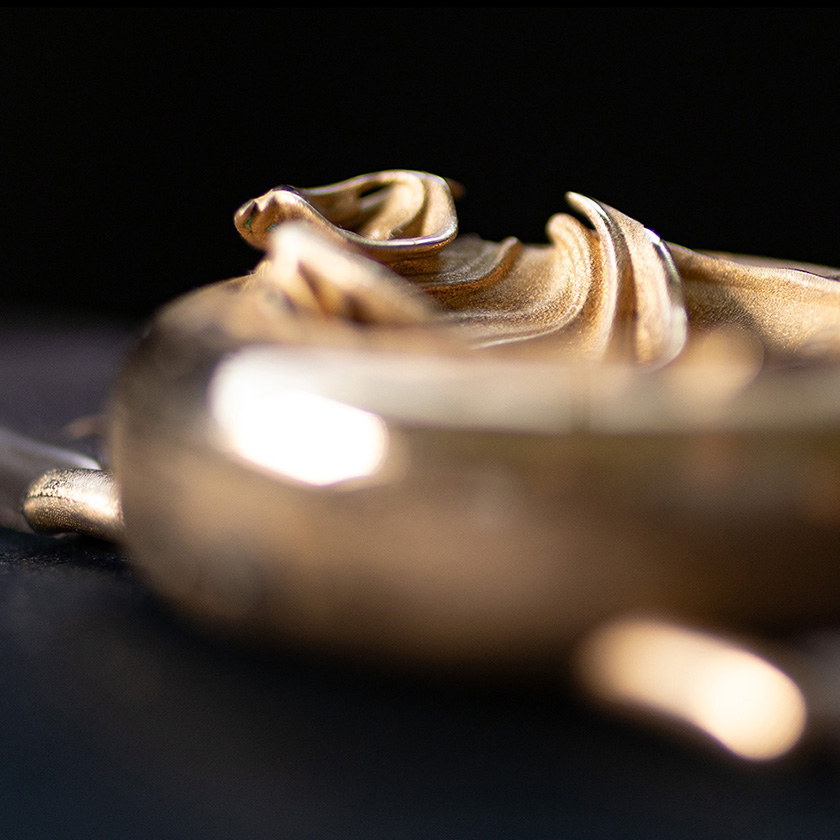 UnconstrainedTime Fractal Emergence 41mm wristwatch in bronze, closeup, shallow depth of field, dark background.