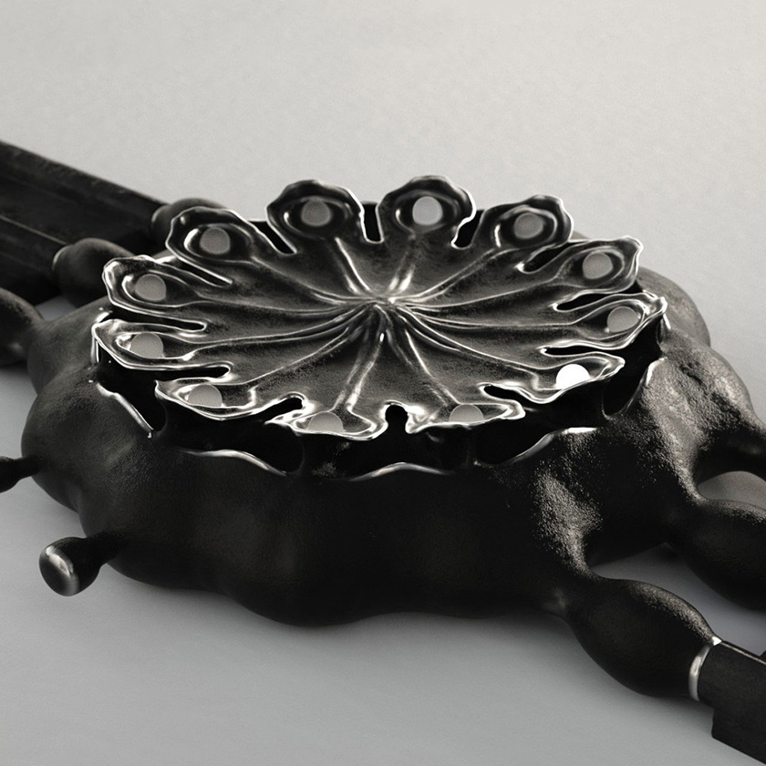 Poppy Seed Pod watch in black patinated bronze, on a white surface.
