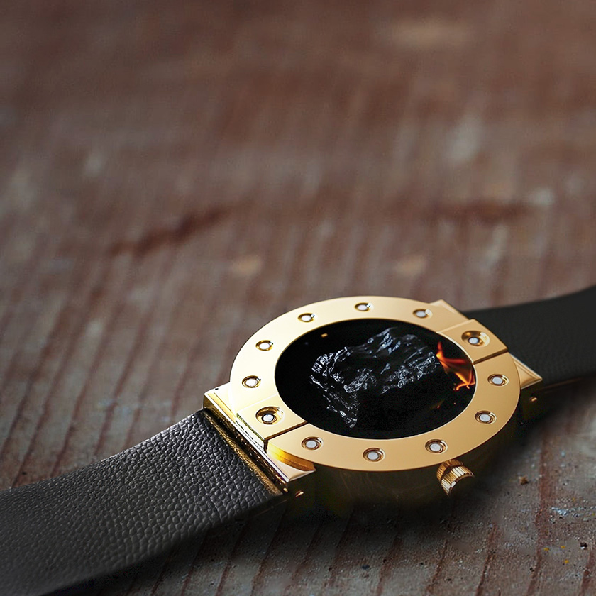 Stone-hold watch in gold with black lava on an old wooden table.