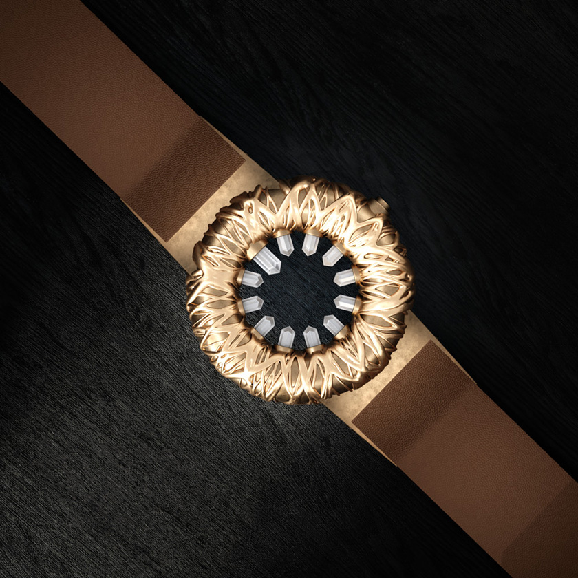 Tropical Crystal wristwatch in bronze, top-down view on a black wood surface.